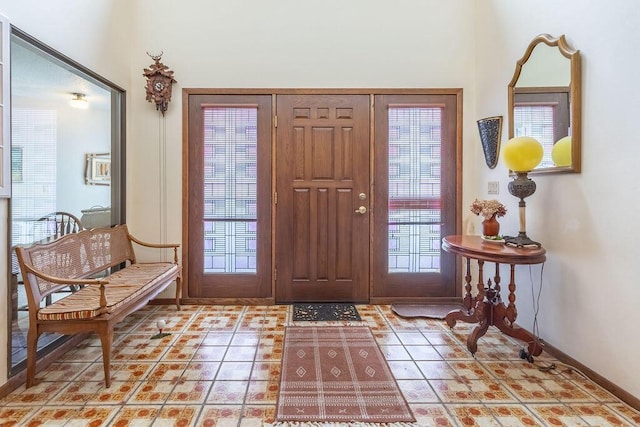 entryway featuring baseboards and light tile patterned floors