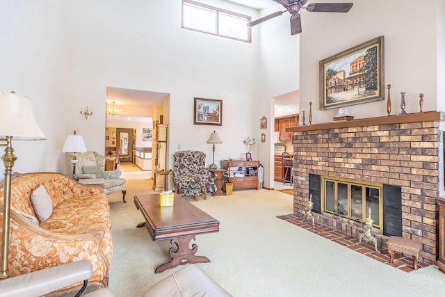 carpeted living room with a towering ceiling, a brick fireplace, and a ceiling fan