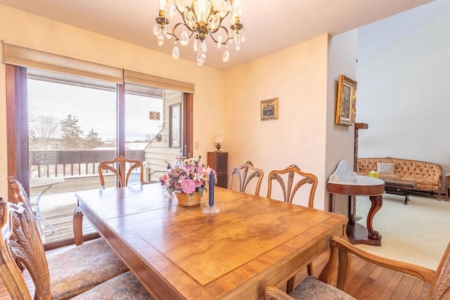 dining area with a notable chandelier and wood finished floors