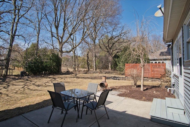 view of patio / terrace featuring outdoor dining area and fence