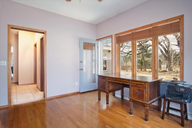 office with ceiling fan, baseboards, and light wood-style floors