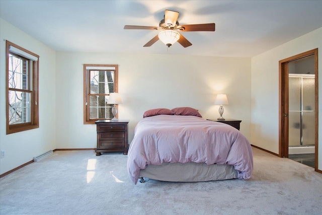 carpeted bedroom with a ceiling fan, a baseboard heating unit, and baseboards