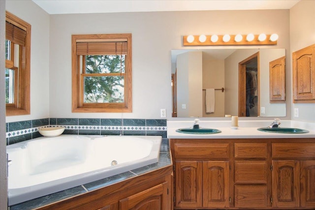 bathroom featuring a sink, a garden tub, and double vanity