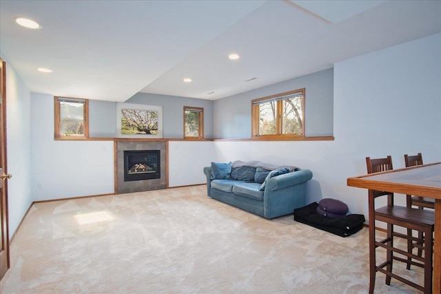 living area featuring carpet flooring, recessed lighting, baseboards, and a tile fireplace