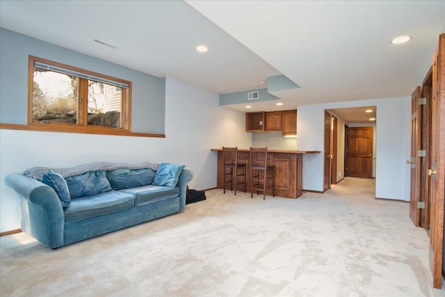 living area featuring recessed lighting, light colored carpet, visible vents, and baseboards