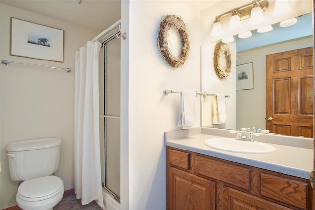 bathroom with vanity, toilet, and a stall shower