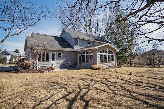 back of house with a patio area, a lawn, entry steps, and a sunroom