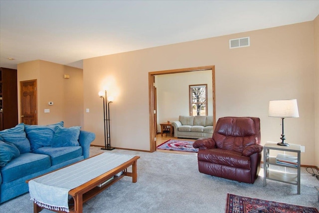 living area featuring visible vents, carpet floors, and baseboards