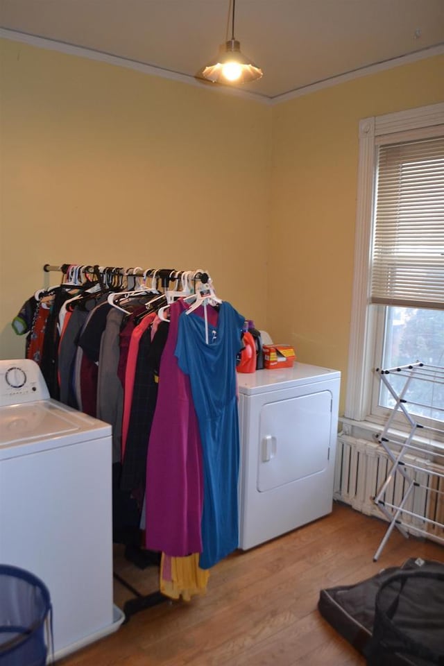 washroom with laundry area, light wood-style flooring, and washer and clothes dryer