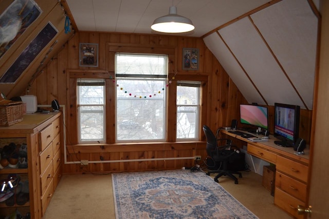 office featuring light carpet, wood walls, and vaulted ceiling