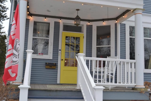 view of exterior entry with a porch