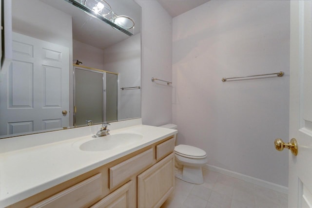 bathroom featuring tile patterned floors, toilet, a stall shower, baseboards, and vanity