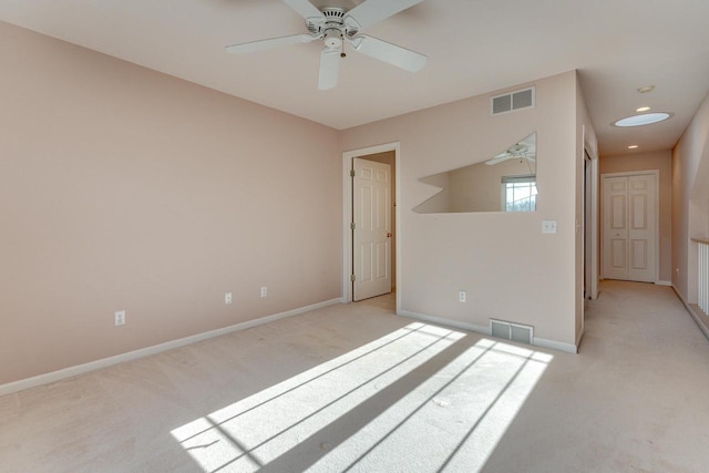 empty room featuring recessed lighting, visible vents, light colored carpet, and baseboards