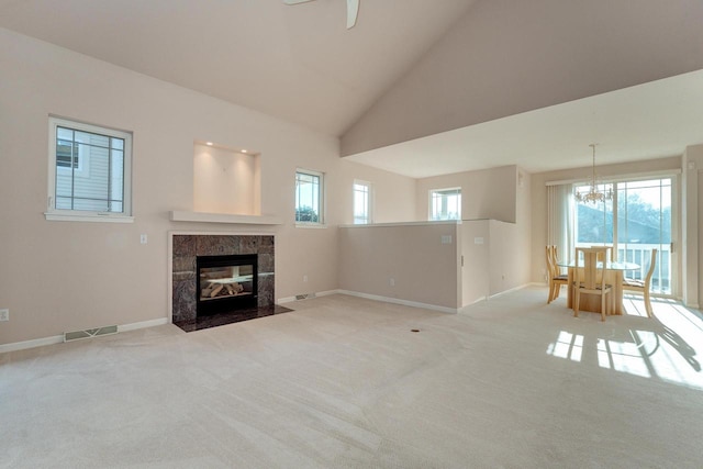 unfurnished living room featuring carpet flooring, a healthy amount of sunlight, and visible vents