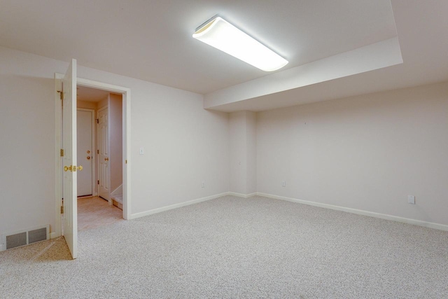 interior space with visible vents, light colored carpet, and baseboards