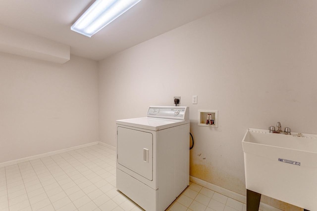 clothes washing area with baseboards, laundry area, washer / dryer, light tile patterned flooring, and a sink