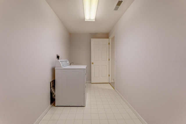 clothes washing area with washer / dryer, light tile patterned floors, baseboards, and laundry area