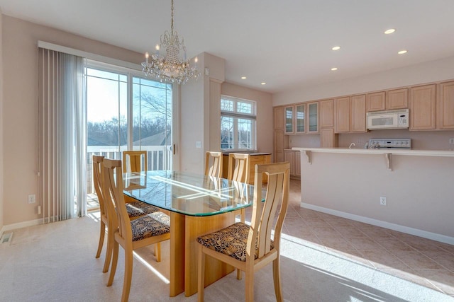 dining space featuring a chandelier, recessed lighting, light carpet, and baseboards