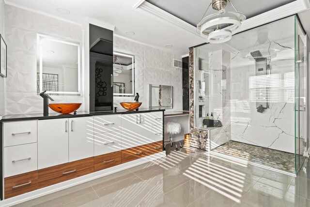 full bath with crown molding, a marble finish shower, a raised ceiling, visible vents, and vanity