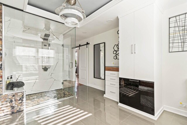 full bathroom with baseboards, a marble finish shower, and a tray ceiling