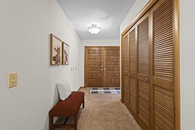 hall featuring tile patterned flooring