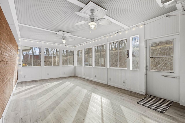 unfurnished sunroom with a ceiling fan