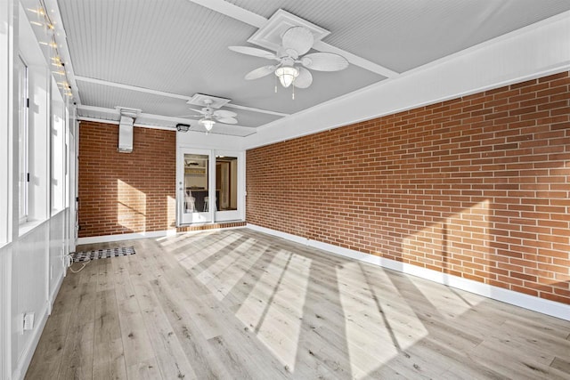 unfurnished sunroom with a ceiling fan