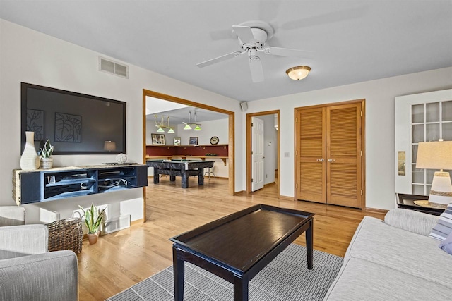 living room with light wood-type flooring, visible vents, pool table, baseboards, and ceiling fan