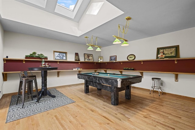 game room featuring pool table, a skylight, baseboards, and wood finished floors