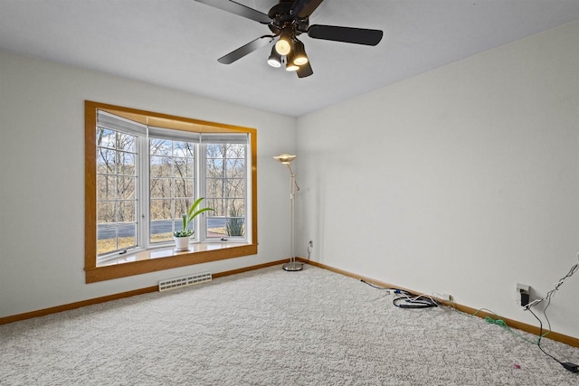 unfurnished room featuring visible vents, baseboards, carpet, and ceiling fan