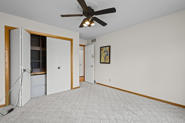 unfurnished bedroom featuring visible vents, baseboards, carpet floors, a closet, and a ceiling fan