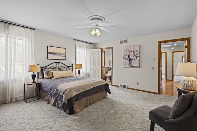 bedroom with visible vents, baseboards, carpet, and ensuite bath