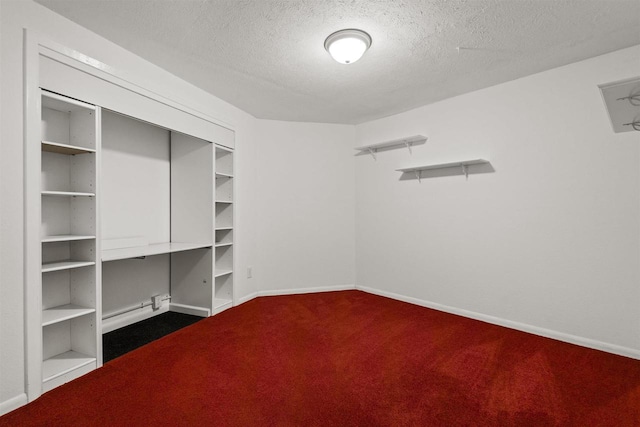 spacious closet with dark carpet