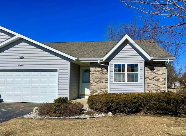 ranch-style house featuring brick siding, driveway, a shingled roof, and a garage