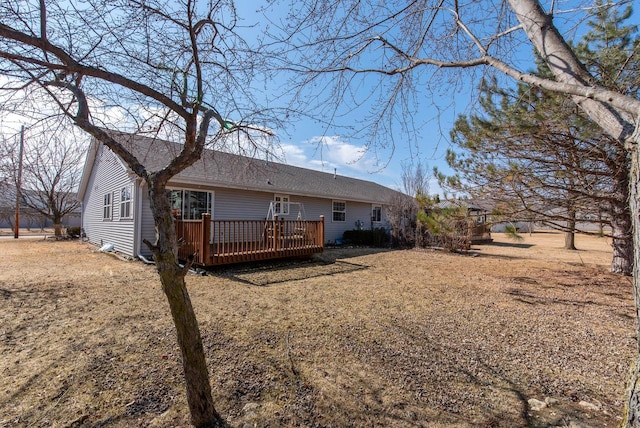 back of property with a wooden deck