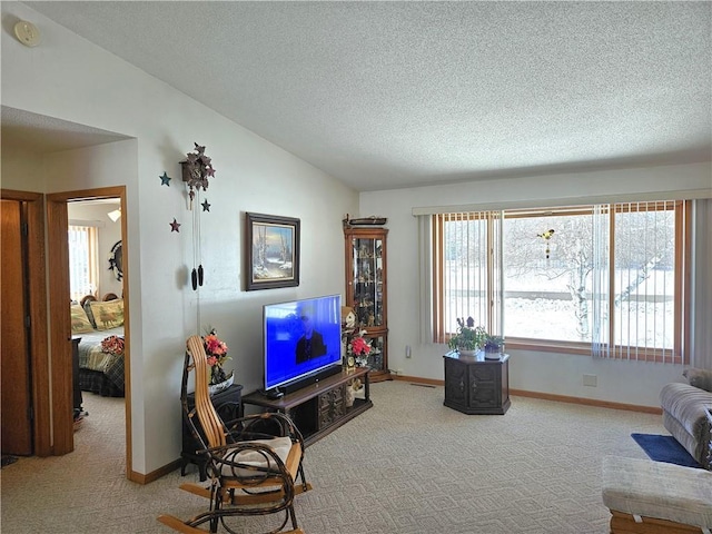 living area featuring carpet flooring, vaulted ceiling, a textured ceiling, and baseboards