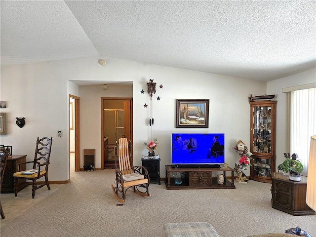 living room with a textured ceiling, vaulted ceiling, and carpet flooring