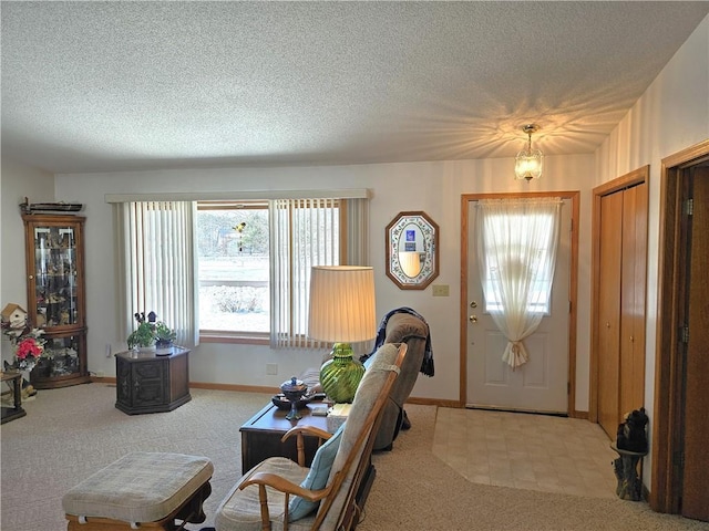 interior space featuring a textured ceiling and baseboards