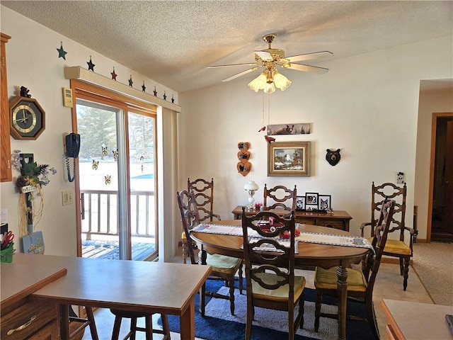 dining space with ceiling fan and a textured ceiling