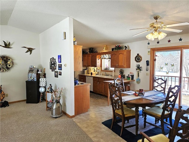 dining room with baseboards, lofted ceiling, ceiling fan, a textured ceiling, and light floors