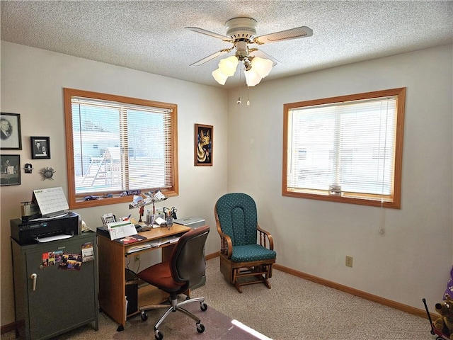 office featuring carpet flooring, ceiling fan, a textured ceiling, and baseboards