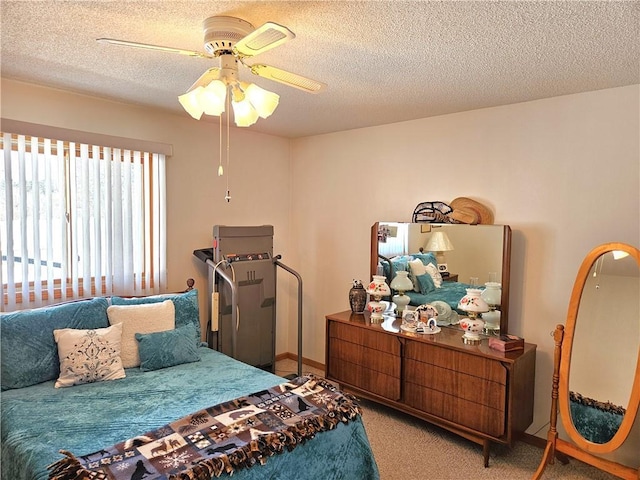 carpeted bedroom with baseboards, a ceiling fan, and a textured ceiling