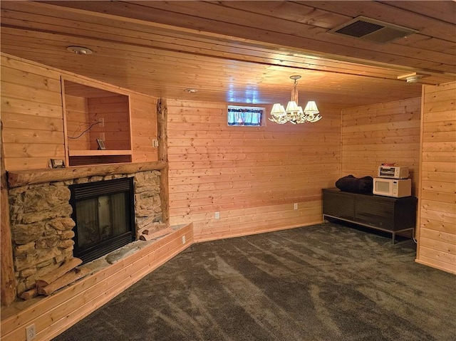 living room featuring wooden ceiling, visible vents, dark carpet, and wooden walls