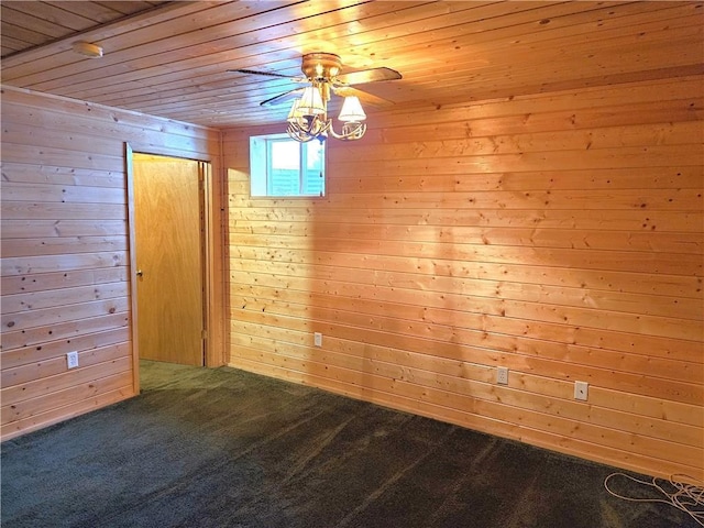 carpeted spare room featuring a ceiling fan, wood ceiling, and wooden walls