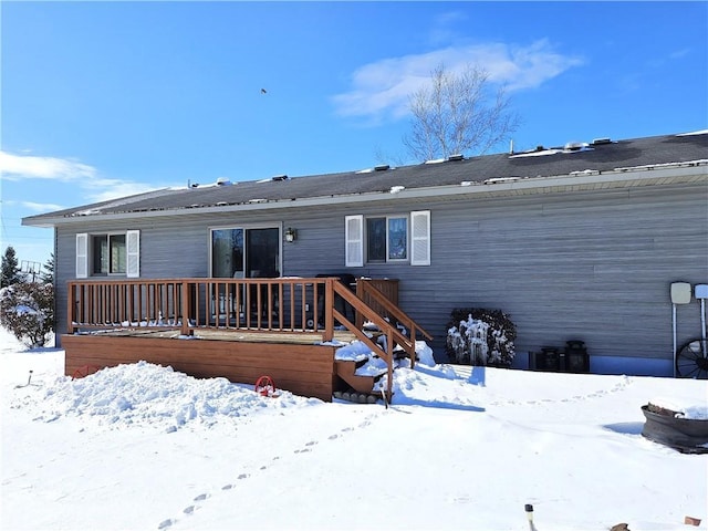 snow covered property featuring a deck