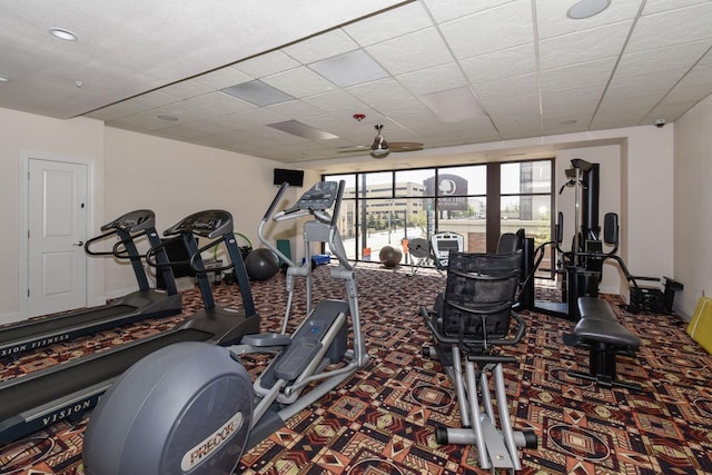 workout area featuring carpet flooring, a ceiling fan, and baseboards