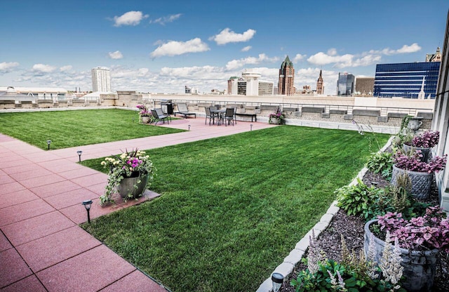 view of yard featuring a view of city and a patio area