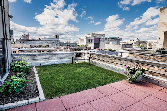 view of yard with a view of city and a balcony