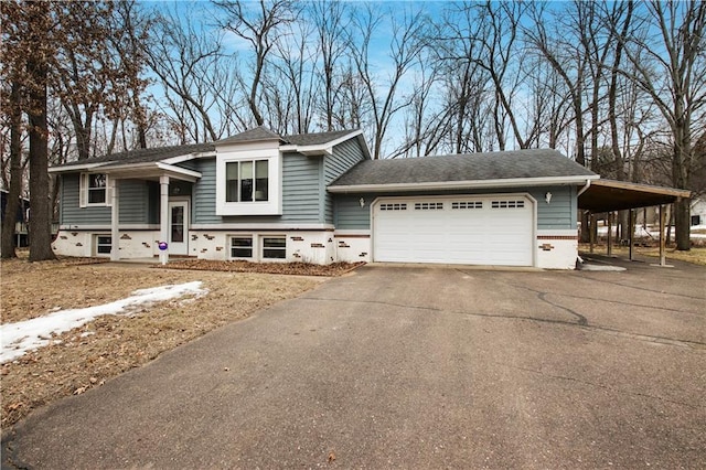 view of front of property with driveway, roof with shingles, a carport, a garage, and brick siding