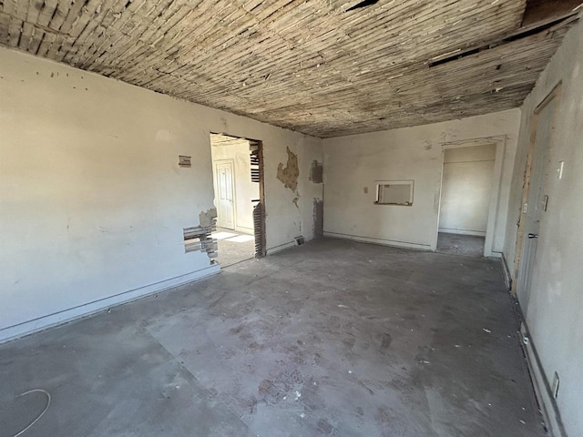 unfurnished room featuring unfinished concrete floors